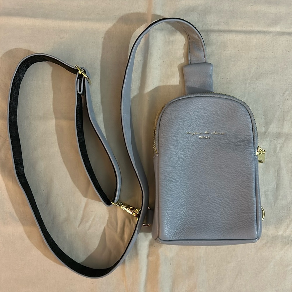 baby blue inicat crossbody bag with gold zippers and clip